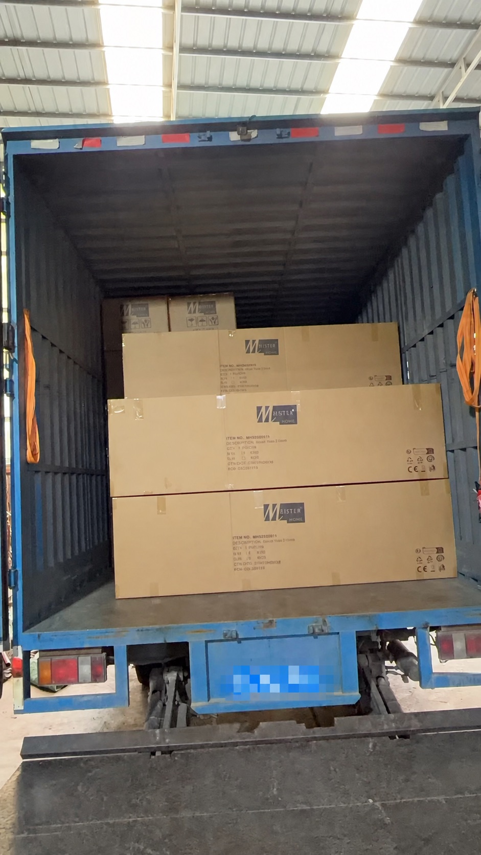 Artificial plant cartons being loaded into a container